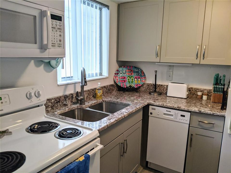 Stone countertops, new cabinets, updated appliances incl mini dishwasher