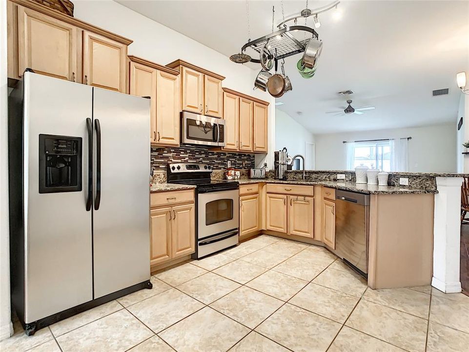 Kitchen with a view of dining and living room