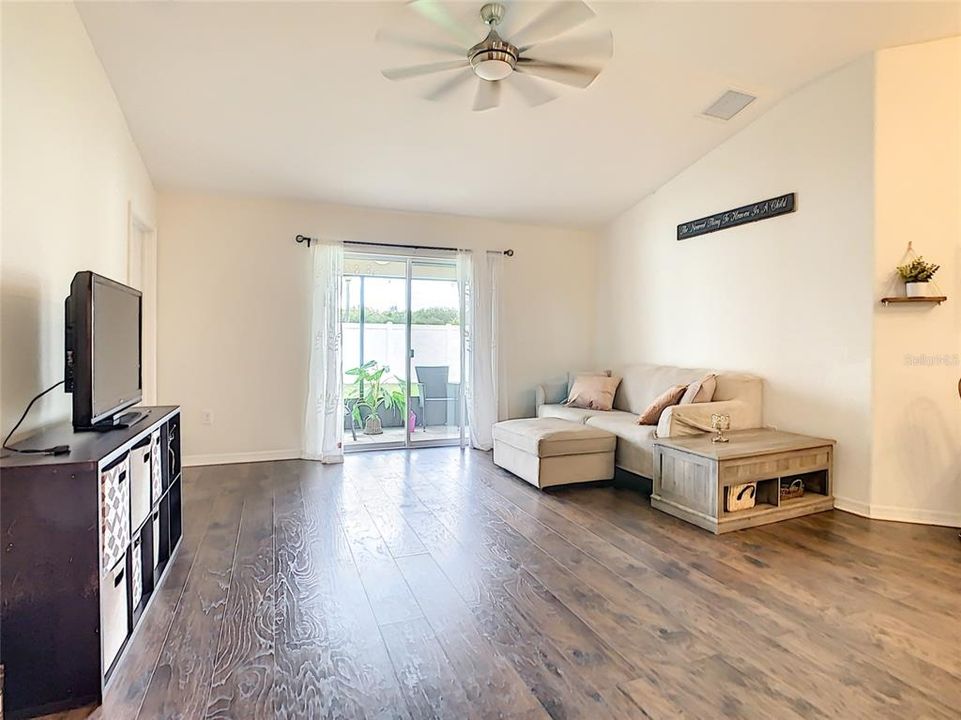 living room with sliding glass door to screened-in Lanai and backyard