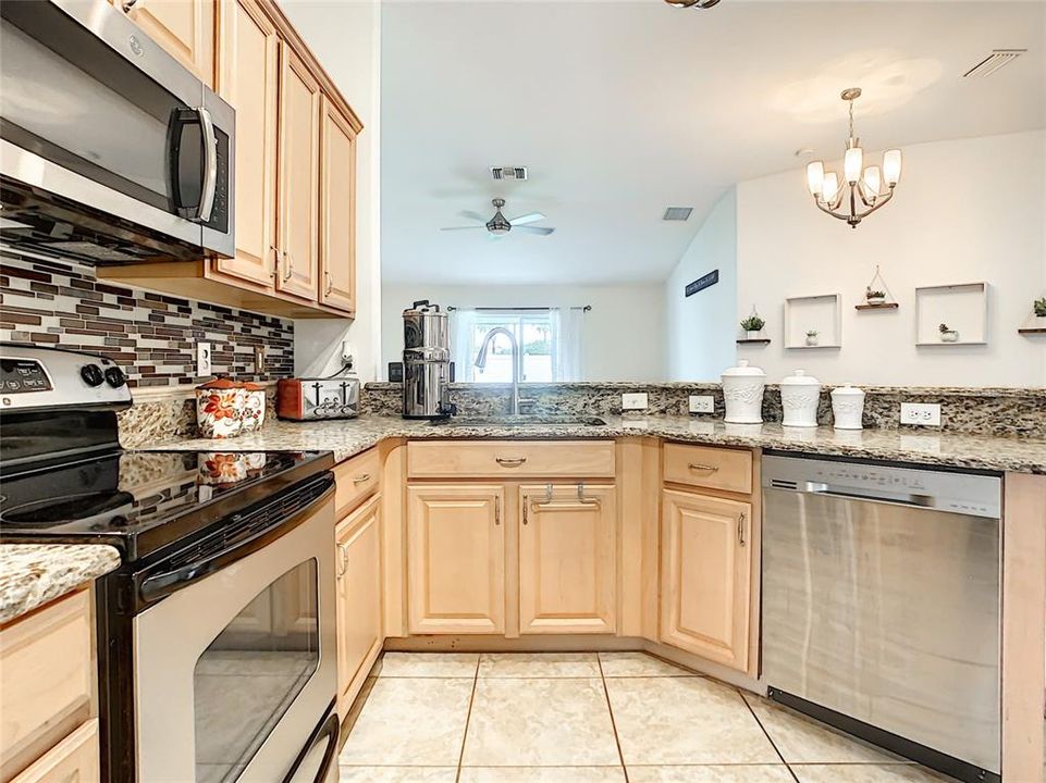 Kitchen with a view of dining and living room