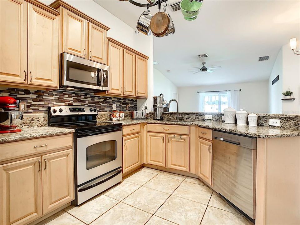 Kitchen - staggered 42 inch upper cabinets and stainless steel appliances