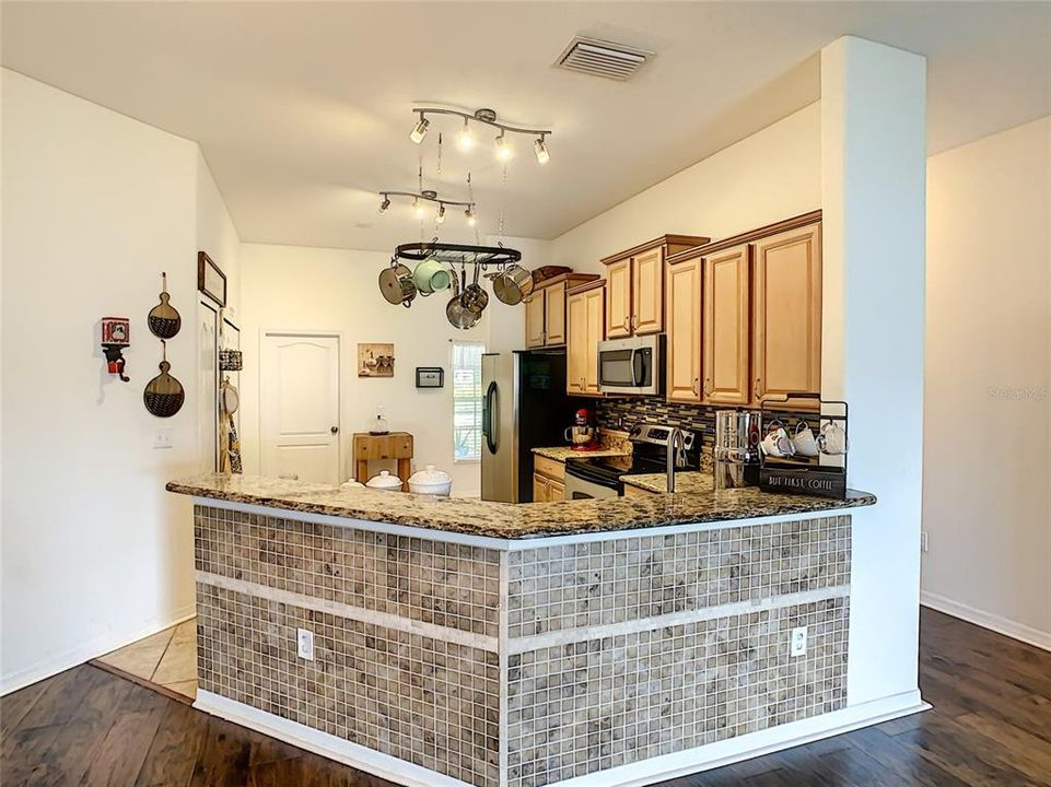 View of kitchen, kitchen island and stainless steel appliances