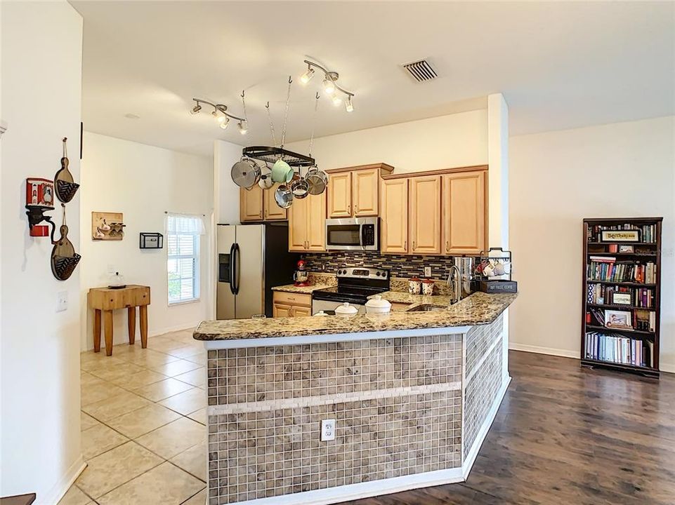 View of kitchen, kitchen island and stainless steel appliances