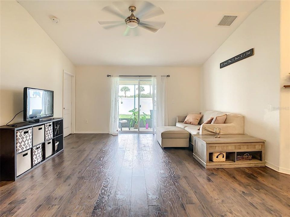 living room with sliding glass door to screened-in Lanai and backyard