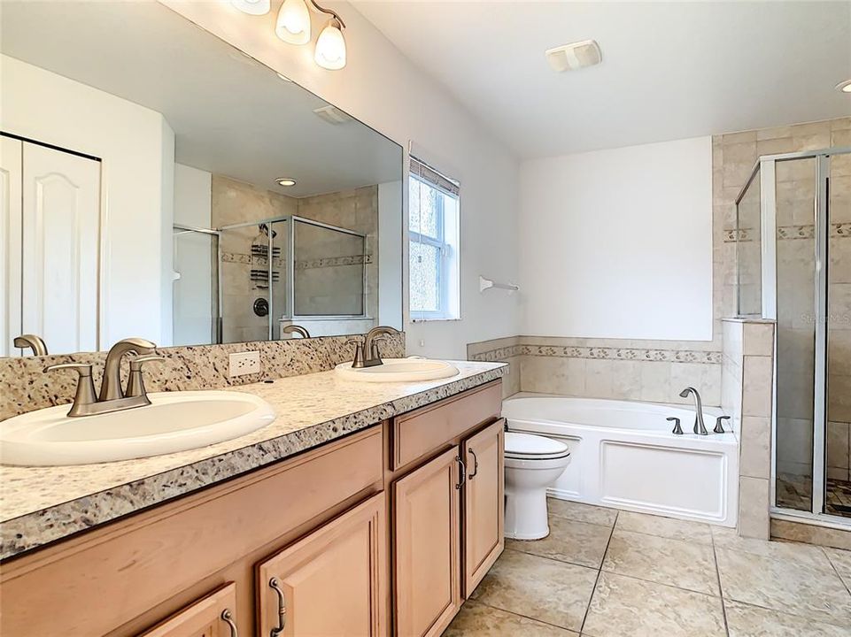 Owners bath with double sinks, garden tub and walk-in shower