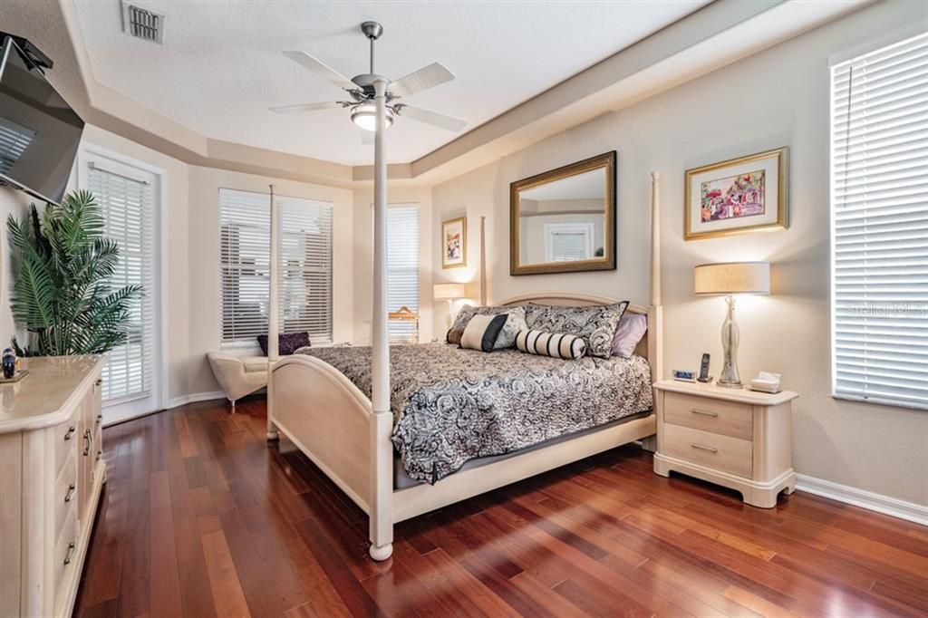 Master bedroom with trey ceiling and hardwood floors