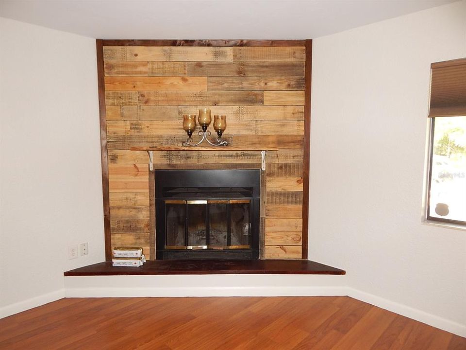 Fireplace with repurposed wood wall.