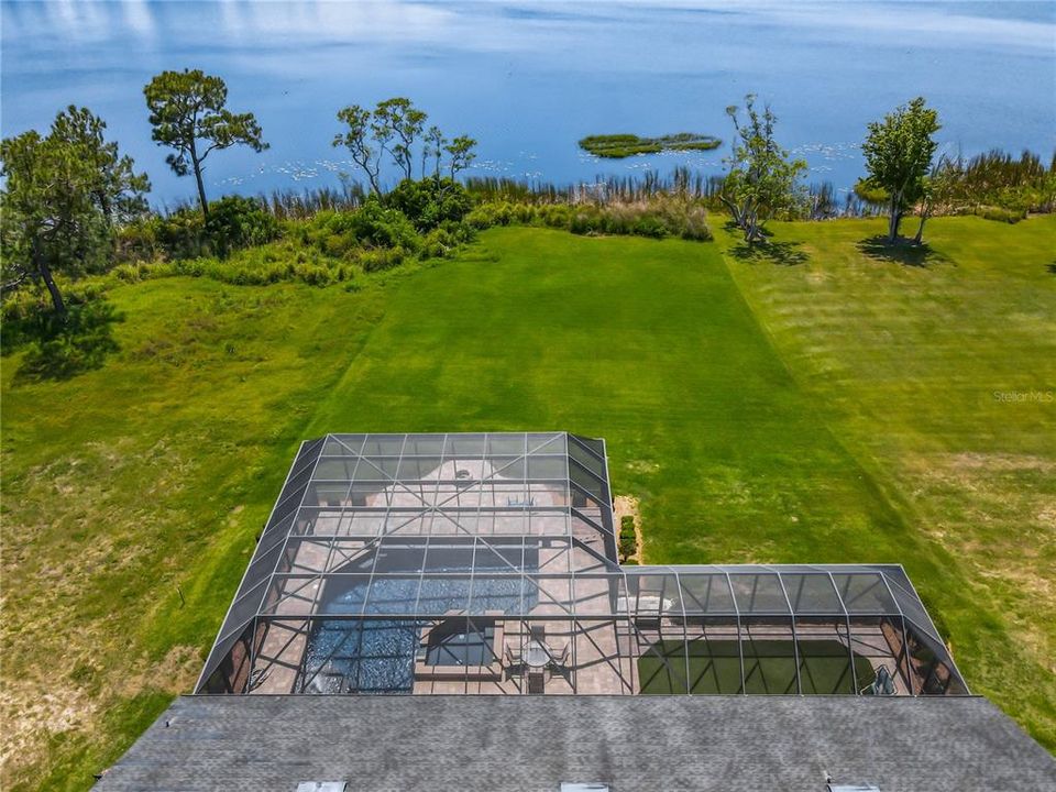 Aerial View of Home With Large Backyard and Lake