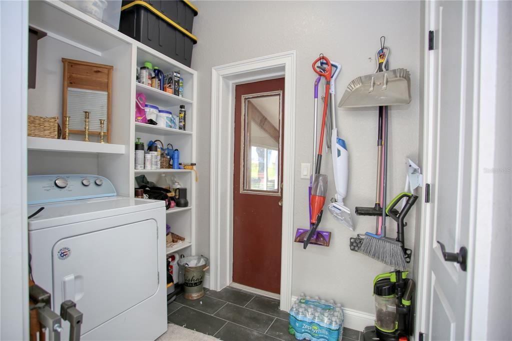 Laundry room with dryer and storage