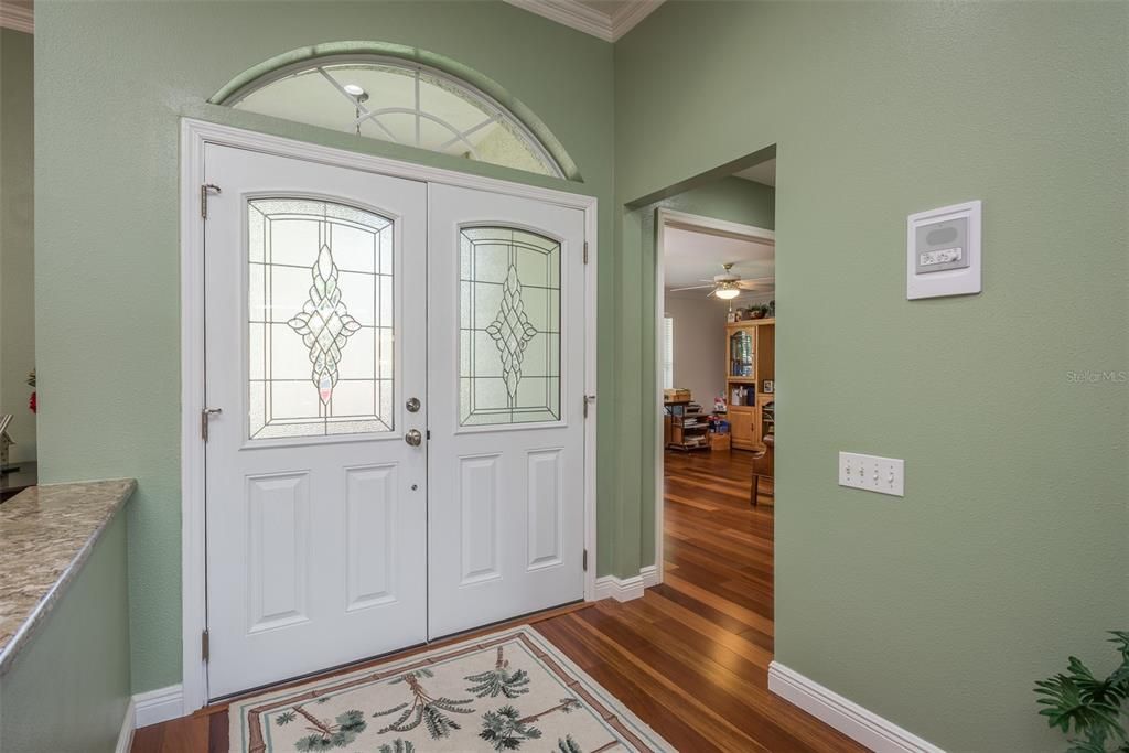 Double front doors, with office and half-bath to the right in the photo, dining room to the left.