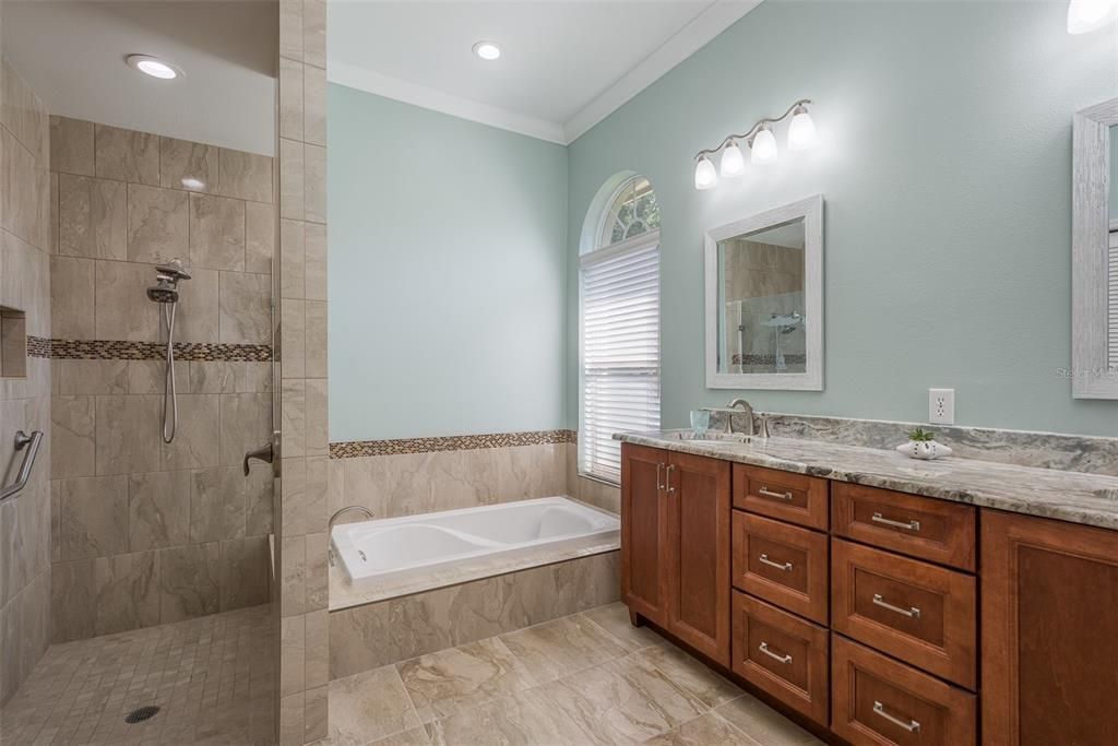 Updated master bathroom features a garden tub and dual sinks.
