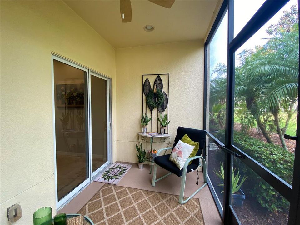 Screened Lanai with ceiling fan, storage closet and garden view