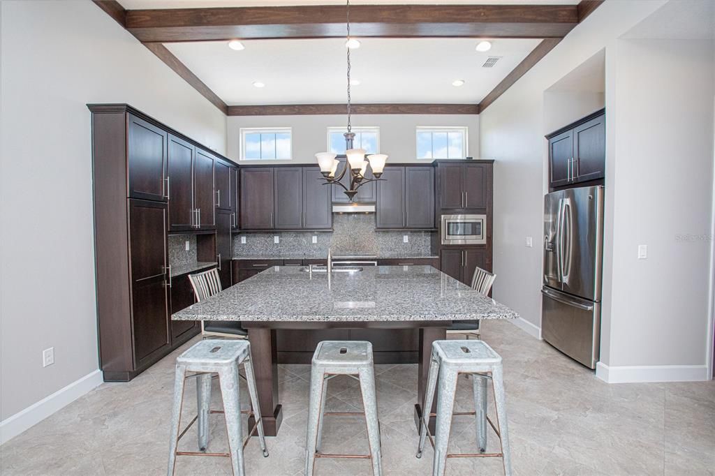 Kitchen features a large center island with breakfast bar.