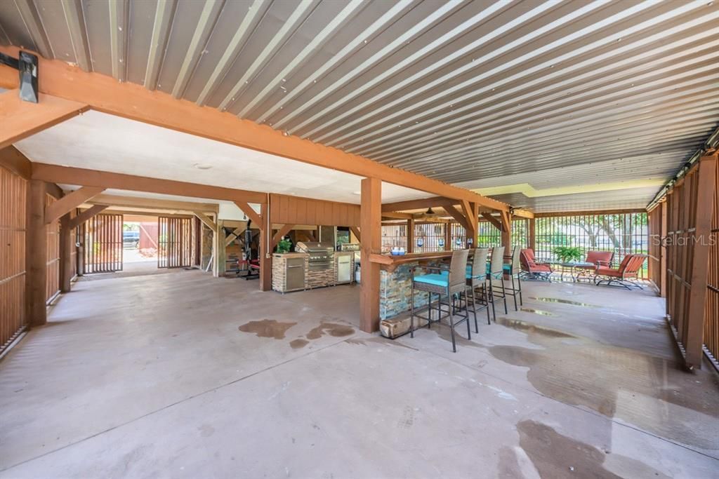 Ground level Outdoor kitchen with Grill/mini frig/bar poolside for entertaining