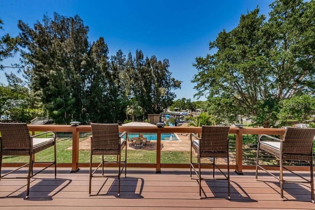 From wrap Trex deck facing the backyard, pool and waterfront area
