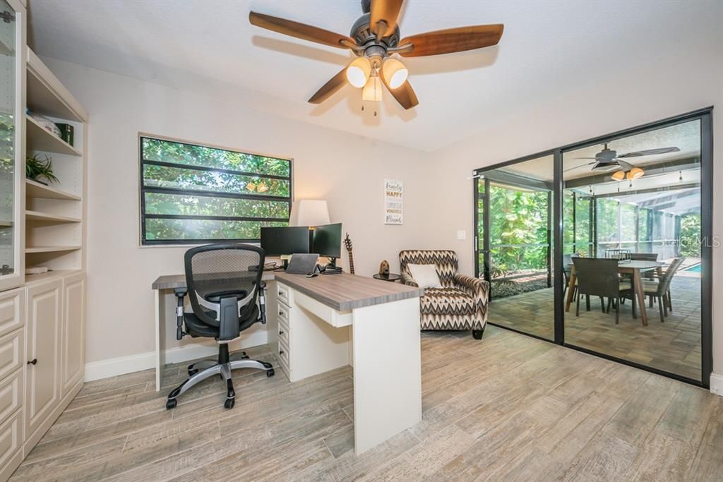 Enjoy the lanai and pool views through the sliding doors in the office