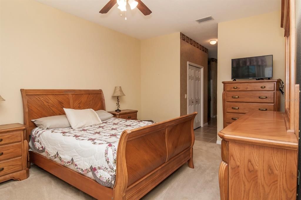 The large master bedroom has quality carpeting and ceiling fan with light kit.