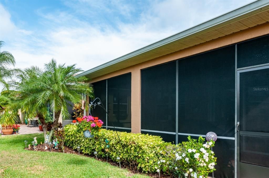 The rear of this quality home has beautiful landscaping including palms.