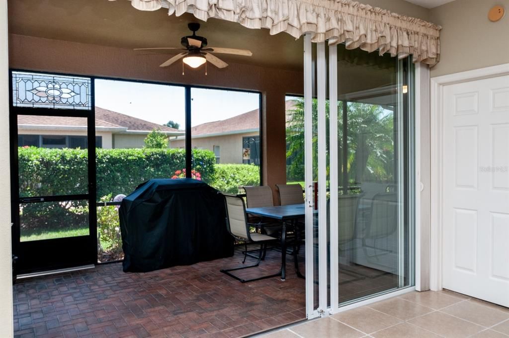 The covered and screened lanai has paver flooring.