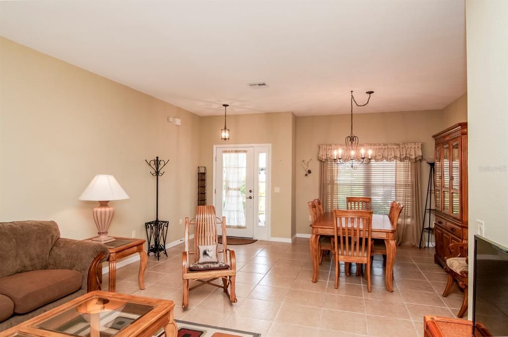 The combination living and dining room has ceramic tile flooring.