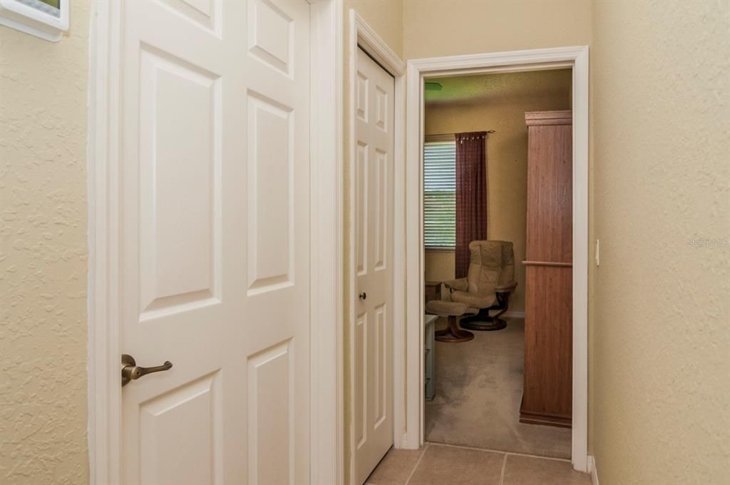 The first door leads to the guest bath. The second door is the linen closet. The 3rd door is open to the 3rd bedroom.