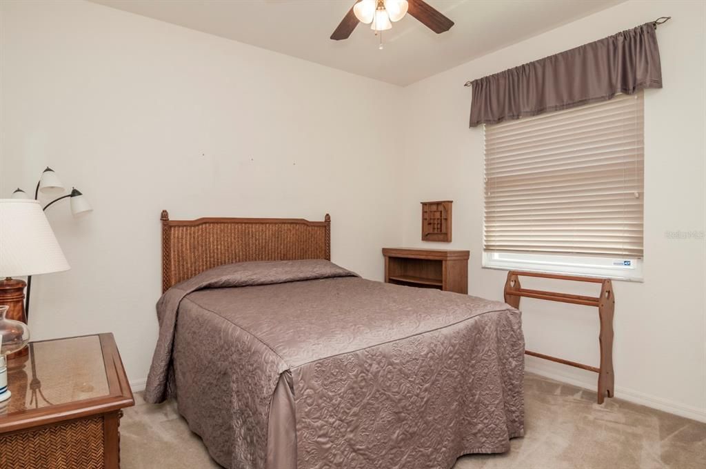 The second bedroom has quality carpeting and ceiling fan with light kit.