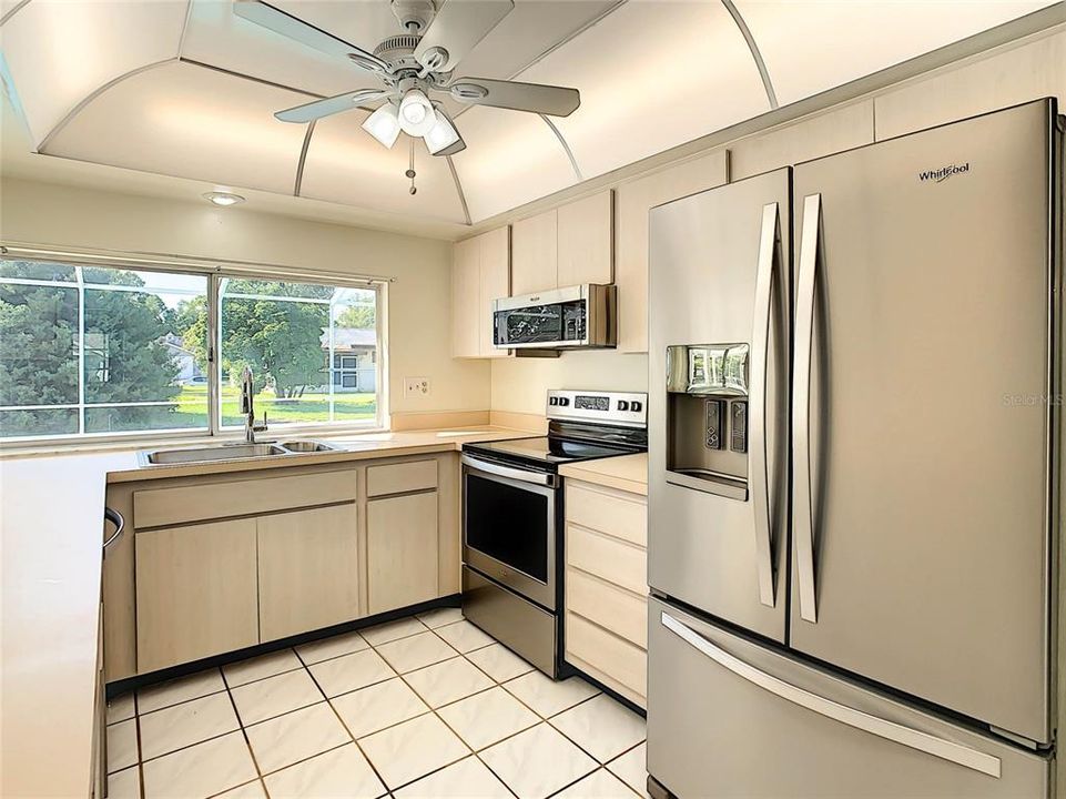 Newer stainless steel appliances and huge window over kitchen sink.