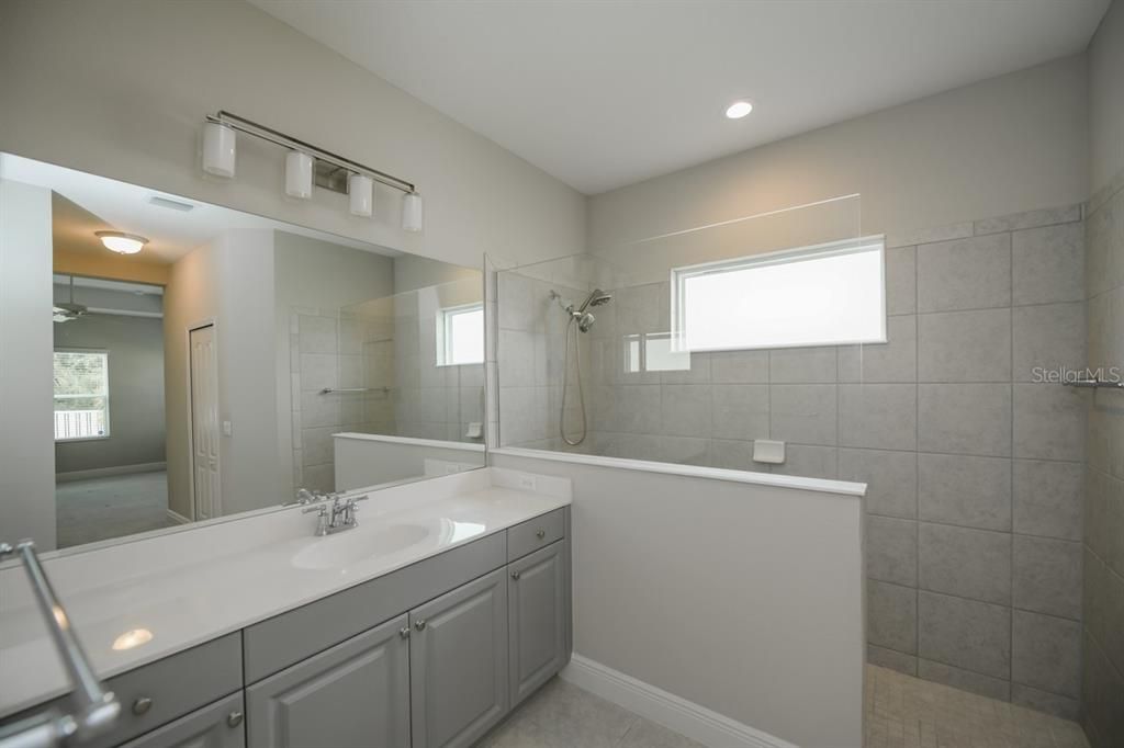Owner's bathroom with frameless walk in shower