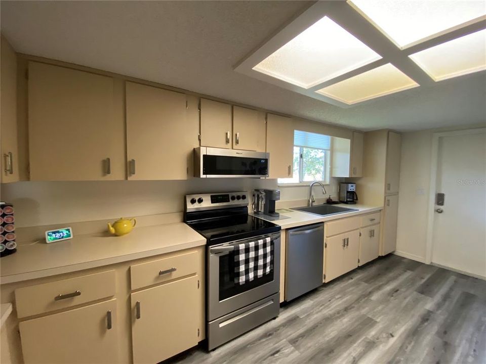 KITCHEN HAS STAINLESS APPLIANCES AND WATERPROOF VINYL PLANK FLOORING