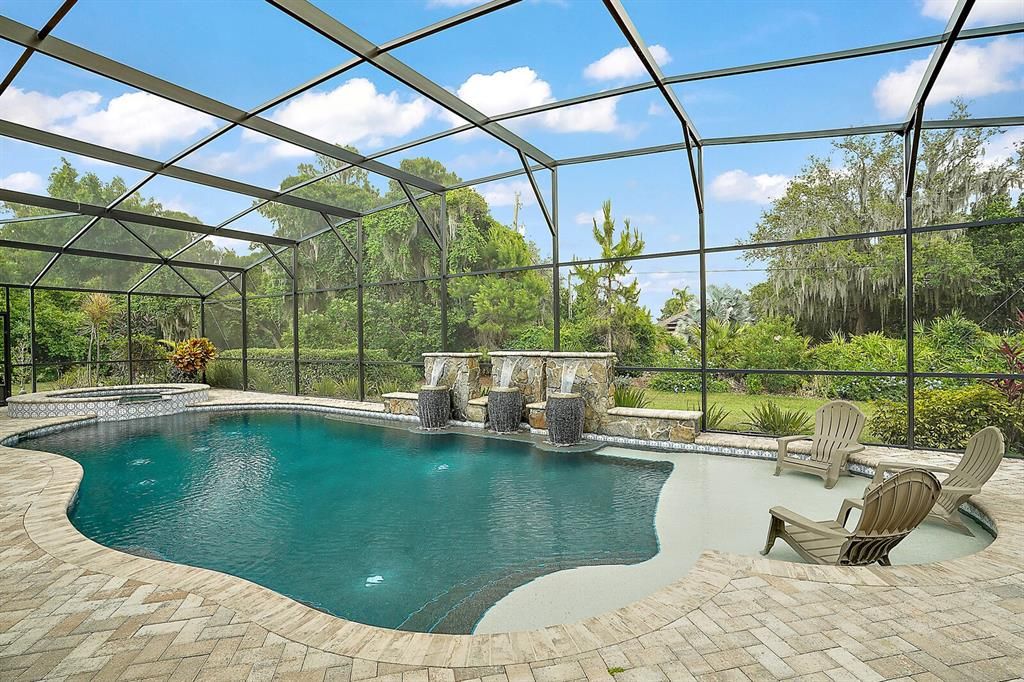 Gorgeous Pool with Waterfall Features, Pavers, and Sun Deck