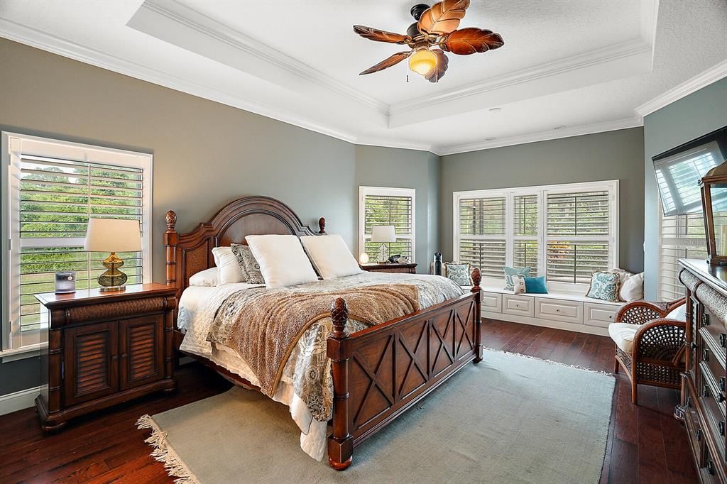 Master Bedroom with Tray Ceiling, Crown Molding, Shutters and Window Seat