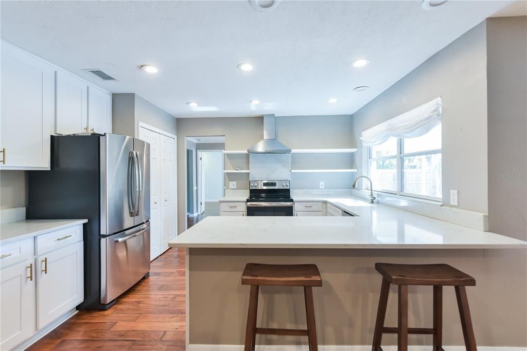 Kitchen has been completely updated with Quartz counters, stainless steel appliances and white cabinetry.