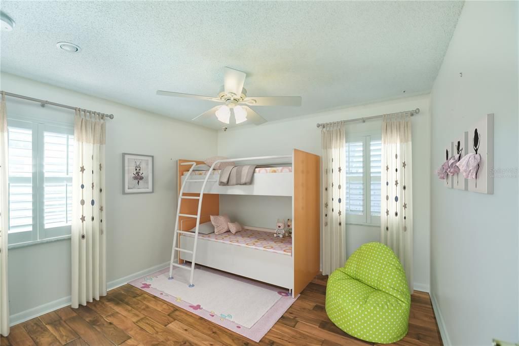 Secondary bedroom is oversized, includes dual windows, plantation shutters and hard wood floors. Virtually staged.