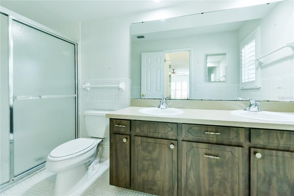 Master bathroom includes dual sinks and walk in shower.