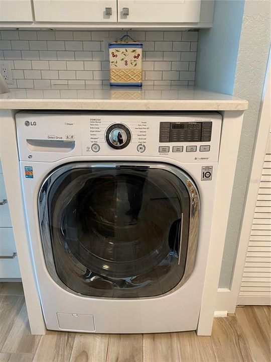 All in one washer/dryer unit in the kitchen for ultimate convenience.