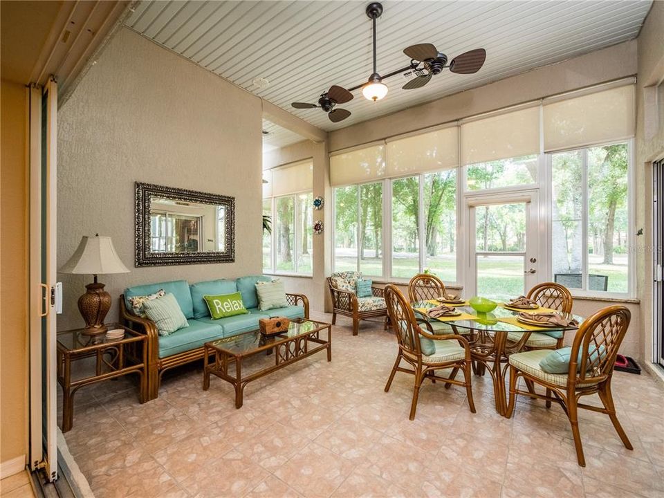 LANAI WITH GLASS TINTED WINDOWS WITH CUSTOM SHADES LOOK OUT TO THE GOLF COURSE!