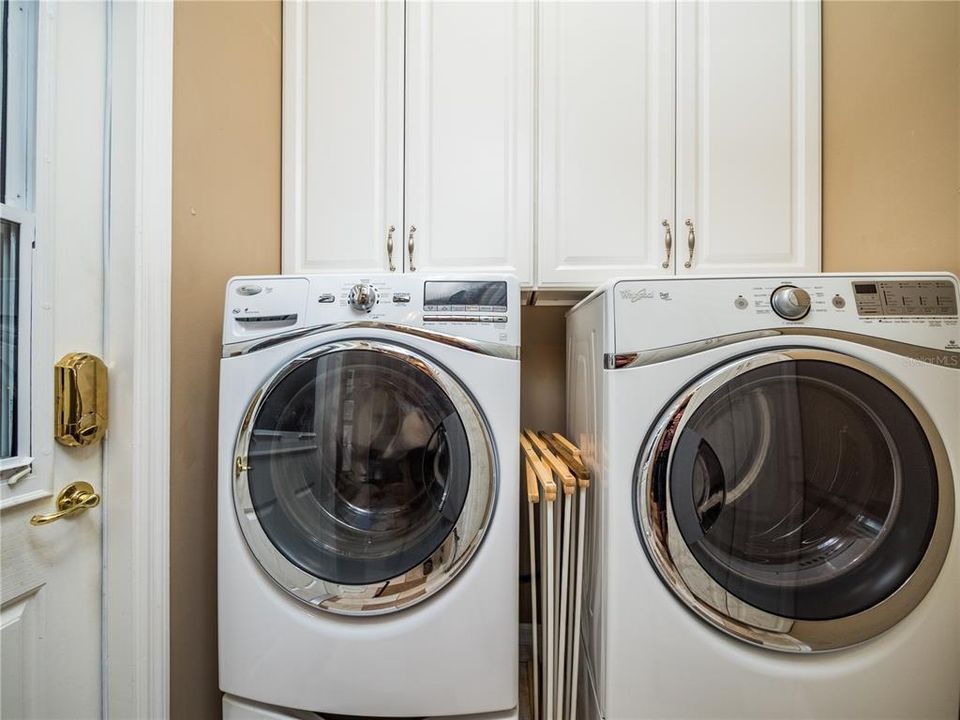 LAUNDRY ROOM WITH FRONT LOAD WASHER AND DRYER, EXTRA CABINETS FOR PLENTY OF STORAGE