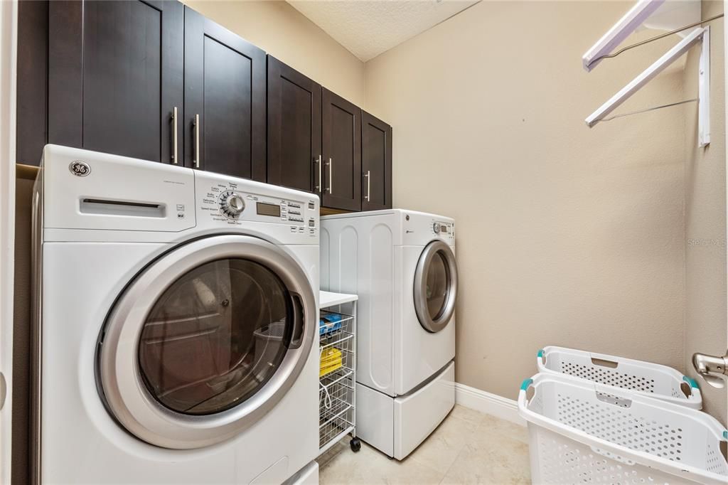 Generous LAUNDRY ROOM has built in cabinets!