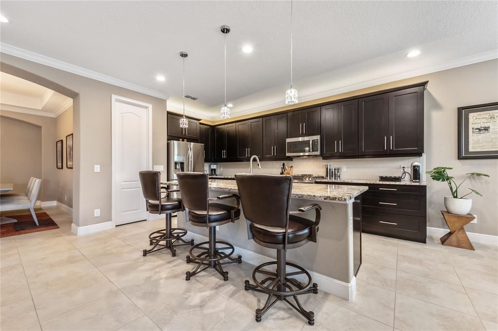 The family chef will fall in love with the upgraded modern kitchen boasting 42??? SOLID WOOD MAPLE CABINETS, GRANITE COUNTERTOPS, GAS RANGE with a DOUBLE OVEN & custom SUBWAY TILE BACKSPLASH!
