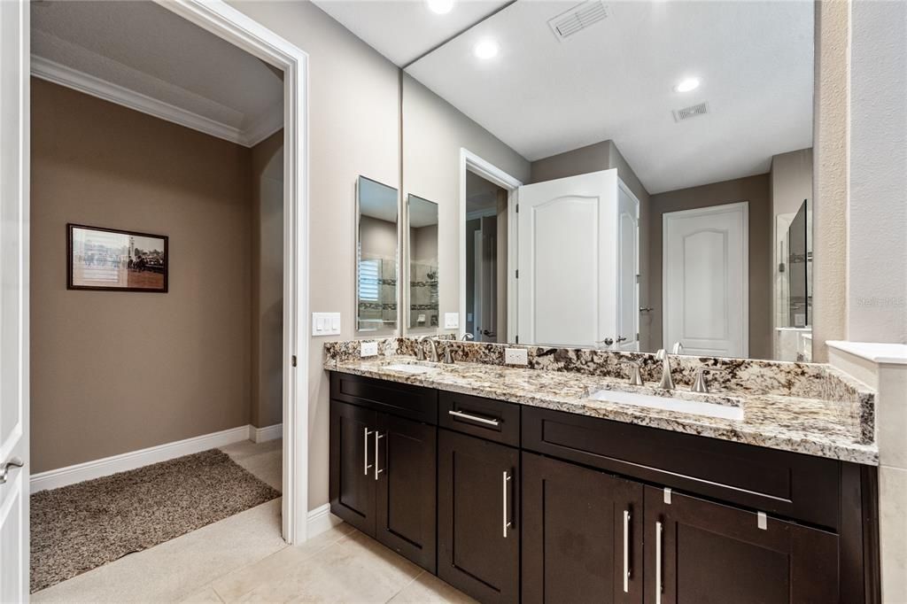 The PRIMARY EN-SUITE BATH offers DUAL SINKS, SOAKING TUB, TILE SHOWER with FRAMELESS GLASS DOORS and a WALK IN CLOSET with BUILT IN customized shelving!