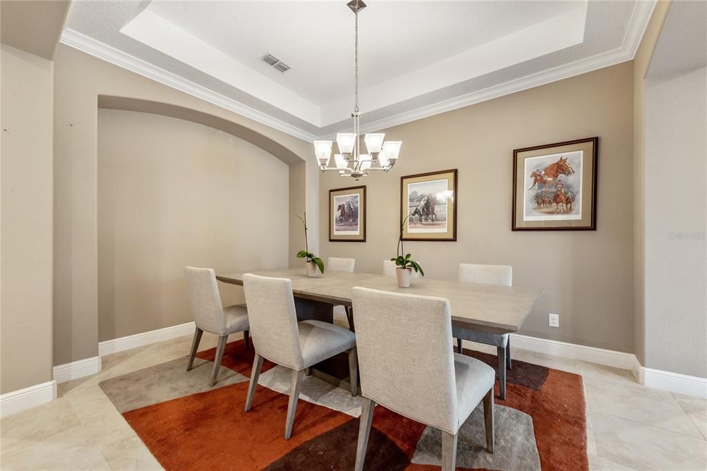 Continue through to the FORMAL DINING where you will notice the CROWN MOLDING and TRAY CEILINGS that add that touch of elegance!