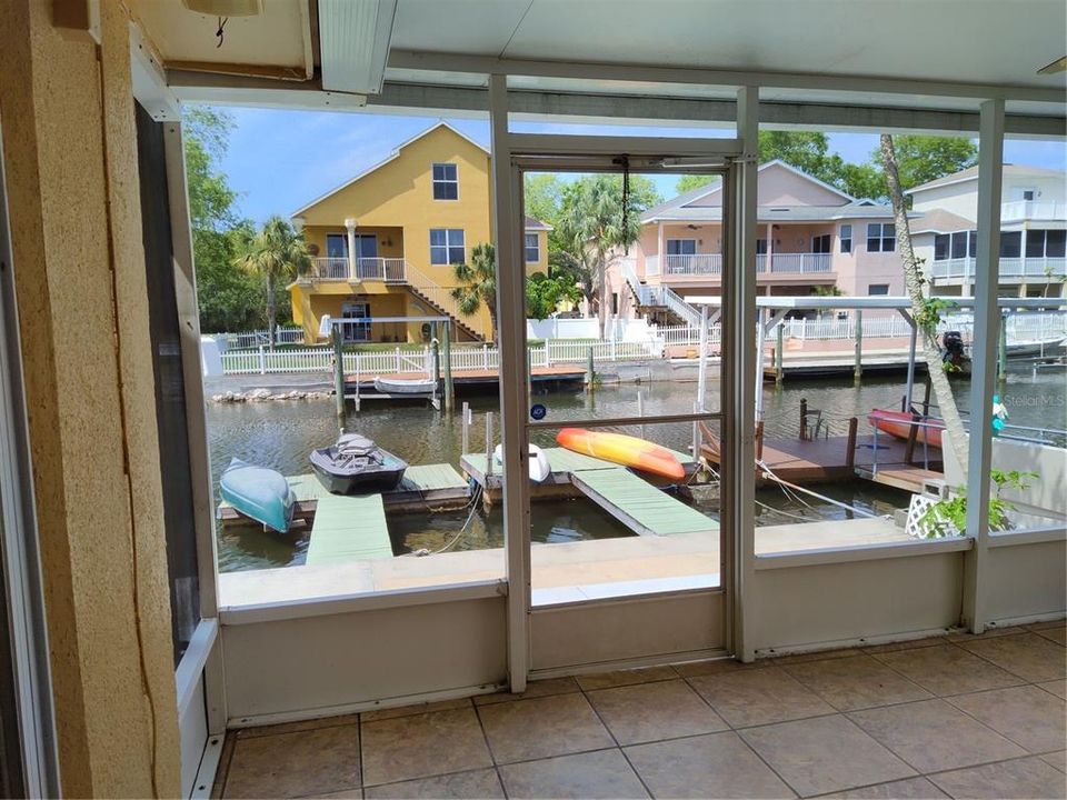 View from the tiled enclosed porch of your 2 floating docks - fishing pier/kayak and canoe launching