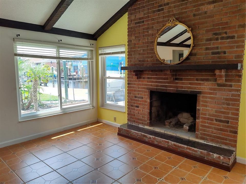 Family room has wood burning fireplace and great view of your canal