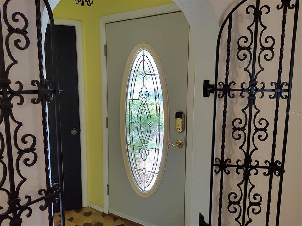 Beautiful front door and decorative wrought iron doors