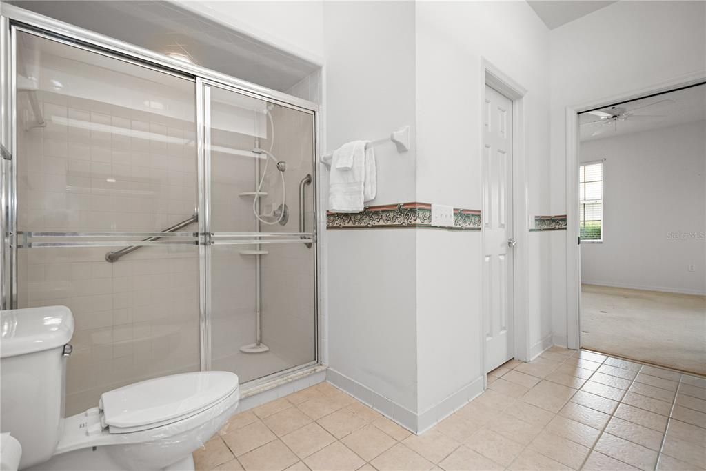 ENSUITE MASTER BATH WITH LARGE SHOWER. CLOSED DOOR LEADS INTO WALK-IN CLOSET. NOTE POCKET DOOR ENTRY TO MASTER BATH!