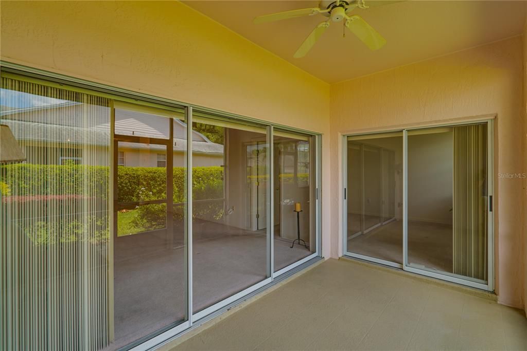 SCREENED LANAI WITH SLIDERS LEADING TO LIVING ROOM AND MASTER BEDROOM SUITE