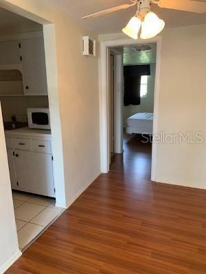 kitchen to the left leading into the Garage, and bedroom with pocket door, one full bathroom