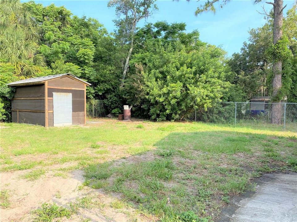 Large private backyard with newer shed.