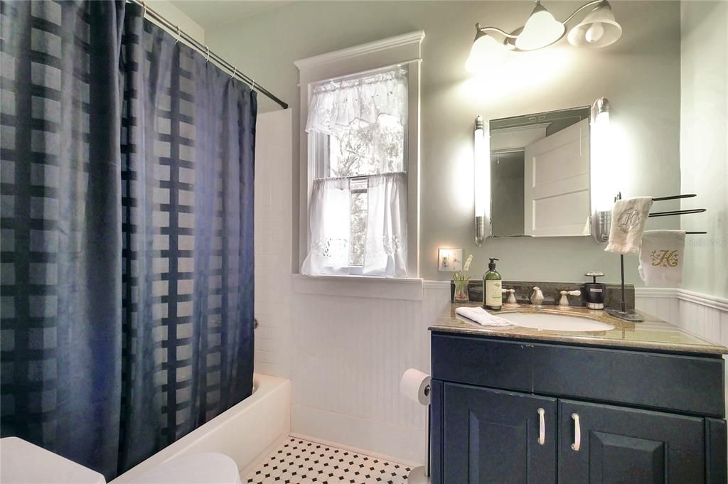 Remodeled upstairs bath with shower in tub.