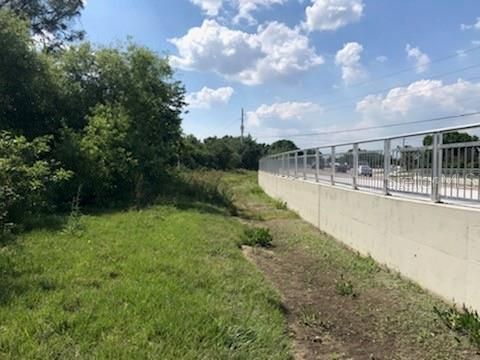 View west toward the lots location on the south side of SR-74.  The road curves here and so the outside of the road is higher elevated than the north side.